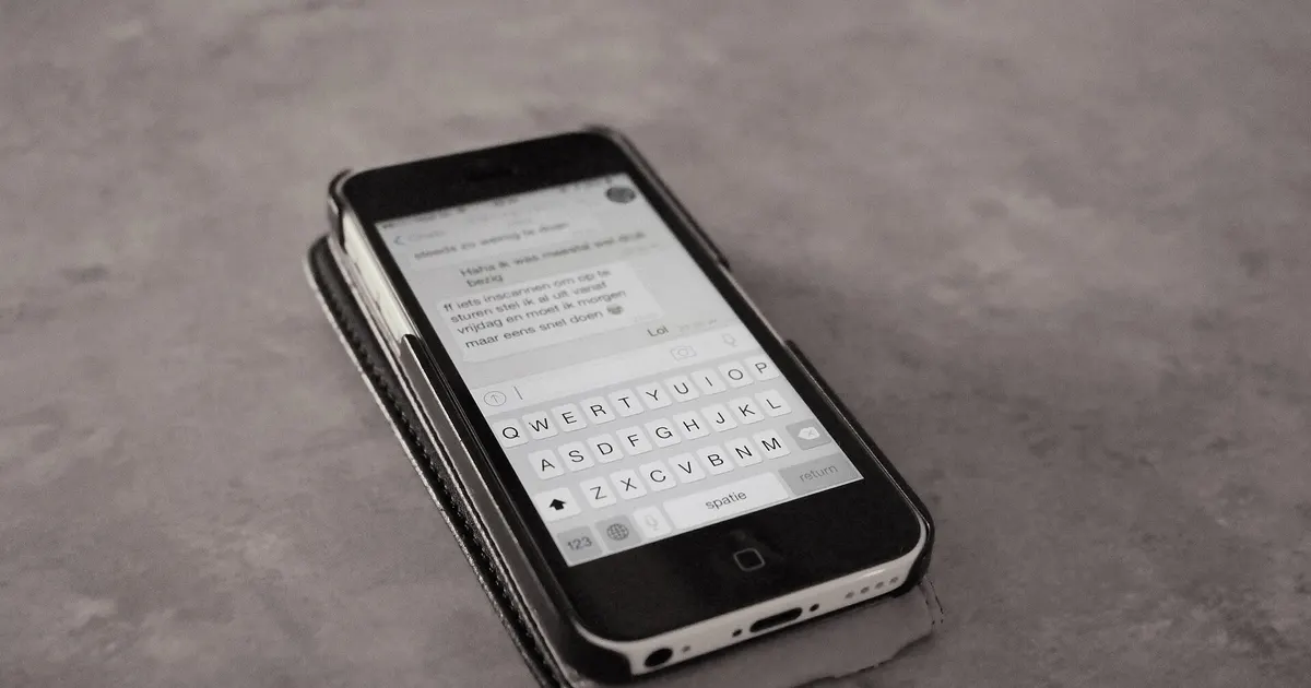 A buyer reading a payment reminder message on a phone